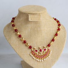 Beautiful fancy pendant with red and white stones studded. For string I have make combination of dholki gold beads and red beads. It gives elegant look. Length is 18 inches. Extra rings are attached. As this is my own design and made by me ,I will make changes according your choice. For any changes please message me. Red Ruby Necklace For Festive Occasion, Red Round Beads Temple Jewelry, Red Pearl Temple Jewelry Necklace For Festivals, Red Pearl Necklace Temple Jewelry For Festivals, Red Temple Jewelry Pearl Necklace For Festivals, Red Ruby Temple Necklace For Celebration, Red Bridal Necklace With Round Beads For Festivals, Festive Red Pearl Necklace With Round Beads, Red Pearl Necklace For Festive Gift