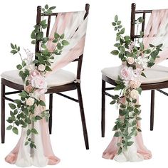 two chairs decorated with flowers and greenery