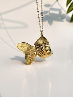 { PRODUCT } -From my Goldfish Collection .This Goldfish necklace made from brass . { SIZE } -goldfish =3x4.5cm. -chain length 72 cm. made in Thailand Goldfish Necklace, Elegant Yellow Gold Fish Shaped Necklace, Fish Necklace Gold, Ryukin Goldfish, Gold Fish-shaped Pierced Earrings, Luxury Yellow Gold Fish-shaped Necklace, Pisces Necklace, Fish Jewelry, Fish Necklace