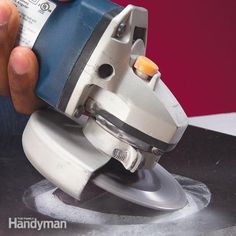 a person using a sander on a piece of paper