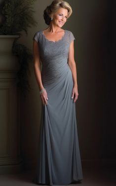 a woman in a gray dress posing for the camera