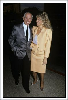 an older man and woman standing next to each other