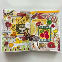 an open book with various stickers and pictures on the pages, including cherries