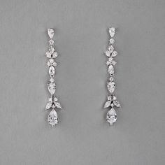 These cubic zirconia elegant beauties are created with dainty stones in pear, marquise, and round shapes. This earring style is 2 inches long, made with AAA CZ, rhodium or gold plated, lead, cadmium, nickel free, and post pierced backs. Cheap Elegant Dangle Hoop Earrings, Cheap Gold Earrings For Anniversary, Cheap Dainty Earrings For Formal Occasions, Luxury Dainty Dangle Jewelry, Cheap Pierced Earrings For Party, Cheap Trendy Dangle Earrings, Affordable Drop Earrings For Anniversary, Luxury Dangle Earrings For Formal Occasions, Elegant Cheap Plated Earrings