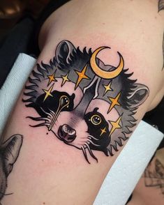 a raccoon with stars and moon on its head is shown in this tattoo design