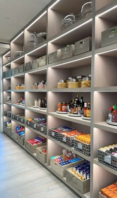 the shelves are filled with food items and containers for sale in an empty storeroom