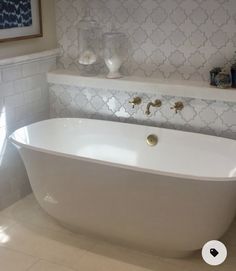 a white bath tub sitting next to a window