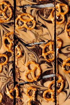 pretzel and chocolate frosted brownies are arranged on top of each other