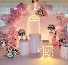 an entrance decorated with balloons and flowers for a fifteen year anniversary celebration at the mansion