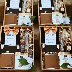 four boxes filled with different types of liquor and condiments, each containing an orange bow