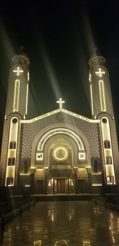 a large church with lights shining on it's sides