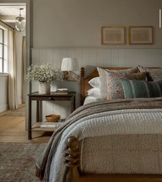 a large bed sitting next to a window in a bedroom