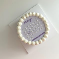 a happy birthday card with a white beaded bracelet