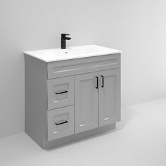 a white bathroom sink sitting under a faucet