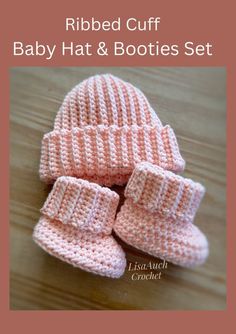 a knitted baby hat and booties set sitting on top of a wooden table