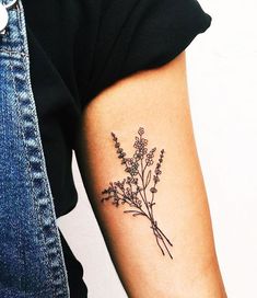 a woman's arm with a flower tattoo on the left side of her arm