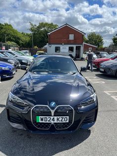 a car parked in a parking lot next to other cars