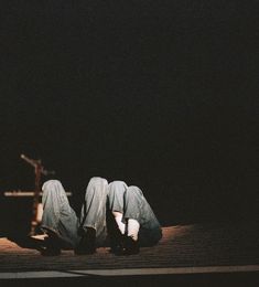 two people laying on the ground in the dark