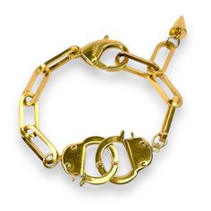 Introducing the **Love Bond Handcuff Chain Bracelet**—a bold, edgy piece that combines style with a hint of playful mischief. Made from tarnish-resistant stainless steel and available in 18K yellow gold or white gold plating, this bracelet features two fully functional handcuff clasps and dual lobster claws, making it adjustable to fit any wrist. Whether worn as a symbol of connection with your partner or as a statement on its own. You can attach your favorite charms, or one of ours, to the hand Handcuff Bracelet, Halo Jewelry, Hand Cuff Bracelet, September Birthstone Jewelry, August Birthstone Jewelry, July Birthstone Jewelry, Lobster Claws, Pearl Jewellery Earrings, Jewelry Ring Box