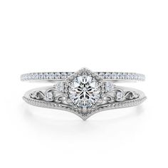 a white gold engagement ring set with an intricate design and round brilliant cut diamonds on the band