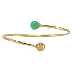 Tiffany & Co hardware ball bypass bangle bracelet. On the side is stamped Tiffany & Co Au750. Gross weight is 8.4 grams. The beads measure 8mm. One bead is green chrysoprase that looks like jade. The sides of the bangle measure 2.4mm thick. Medium size. Inside length measures 6.25 inches. Excellent condition. Tiffany Hardware, Gold Tiffany, Tiffany And Co Bracelet, Tiffany And Co, Tiffany & Co., Bangle Bracelet, Arm Band, Gold Hardware, On The Side