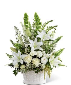 a basket filled with white flowers and greenery