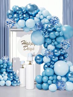 blue and white balloons are arranged in the shape of a arch