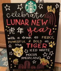 a sign that says celebrate lunar new year with animals and tiger symbols on it in front of a door