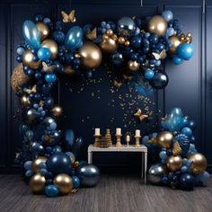 blue and gold balloon arch with confetti