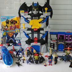 a bunch of toys sitting on top of a white table next to each other in front of a wall