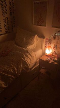 a bedroom with a lit candle on the bed