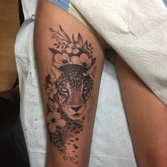 a close up of a person with a tattoo on their arm and the image of a leopard