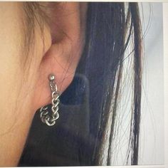 a woman's ear with a chain attached to it