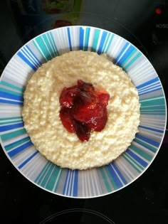 a bowl with oatmeal and strawberries in it