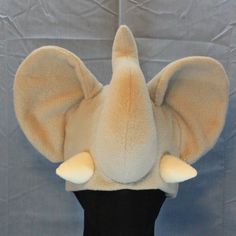 Ultrasoft fleece ELEPHANT ear hat with large freestanding, 3D ears, a solid gray base, a plush upright trunk, and cream tusks.  This hat's cozy layers will keep you warm through the coldest days! Perfect for cold weather outdoor fun, a costume, or to make a statement.  Will fit most adults.  Multiple color variations are available so PLEASE specify which color style is preferred. If choosing the Custom Colors option, please write your color choices in the "Personalization" field. Ear Hat, Fleece Hat, Elephant Ears, Ear Hats, Natural Colors, Multiple Color, Skull Cap, Outdoor Fun, Color Style