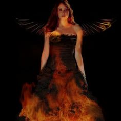 a woman in a dress with wings on fire