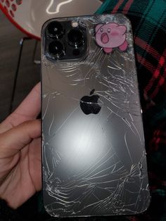 a broken iphone case with a pig sticker on it