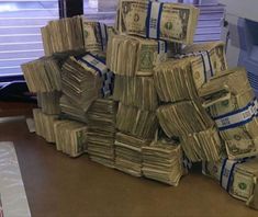 stacks of money sitting on top of an office desk