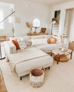 a living room with a large sectional couch and coffee table in the corner, surrounded by other furniture