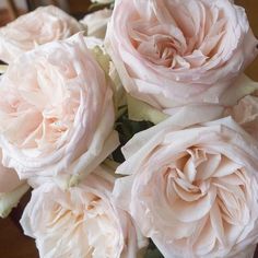 a bunch of pink roses sitting on top of a table