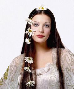 a woman with long hair and flowers in her hair