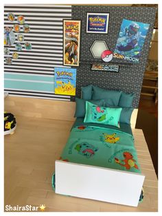 a bed with pokemon themed sheets and pillows in a room that has pictures on the wall