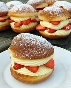 strawberry shortcake sandwiches with powdered sugar on top and strawberries in the middle