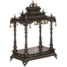 an ornate wooden stand with bells on it