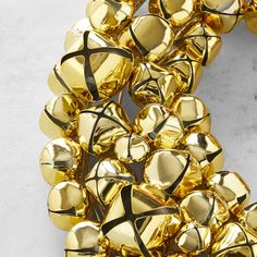 a bunch of gold bells on a white surface