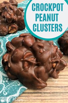 chocolate crockpot peanut clusters on a wooden table with a blue and white towel