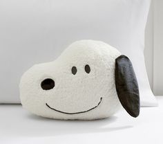 a pillow with a dog's face on it sitting in front of a pillow