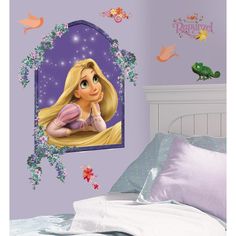 the princess wall decal is in front of a bed with purple walls and pillows