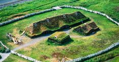 an aerial view of a grass roofed building