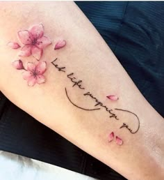 a woman's arm with pink flowers on it and the words, i love you in cursive writing